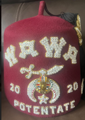 Burgundy three-row jeweled Shriners fez with bright jeweled lettering and emblem