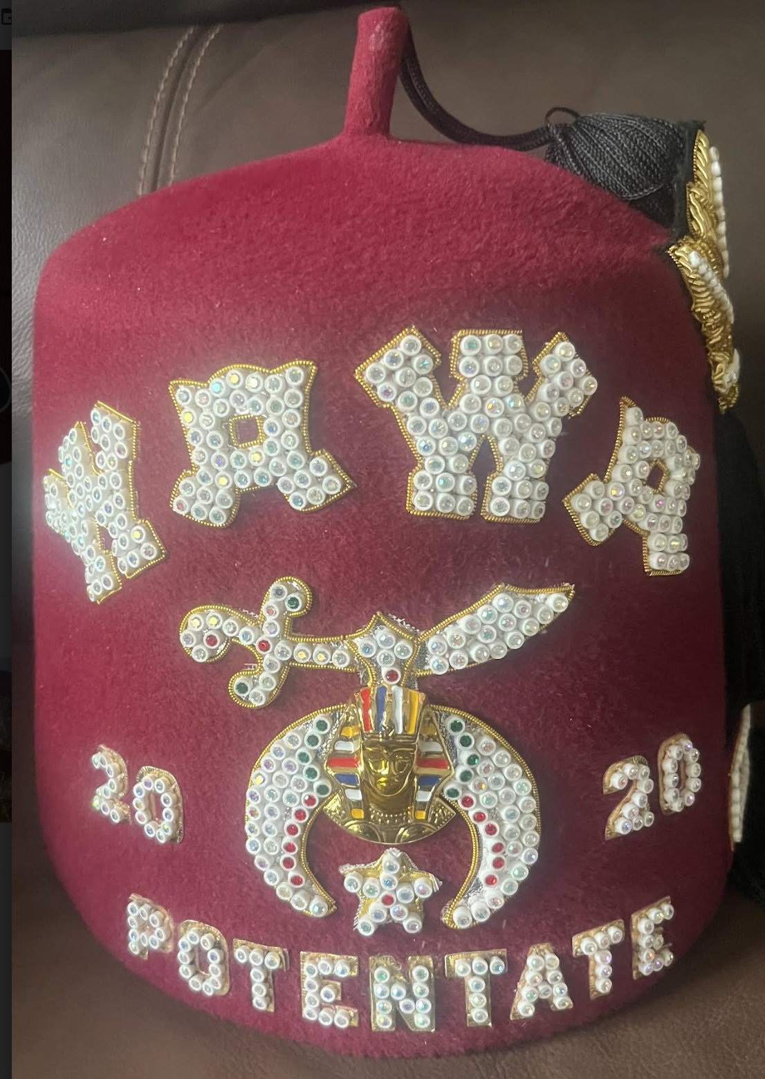 Burgundy three-row jeweled Shriners fez with bright jeweled lettering and emblem