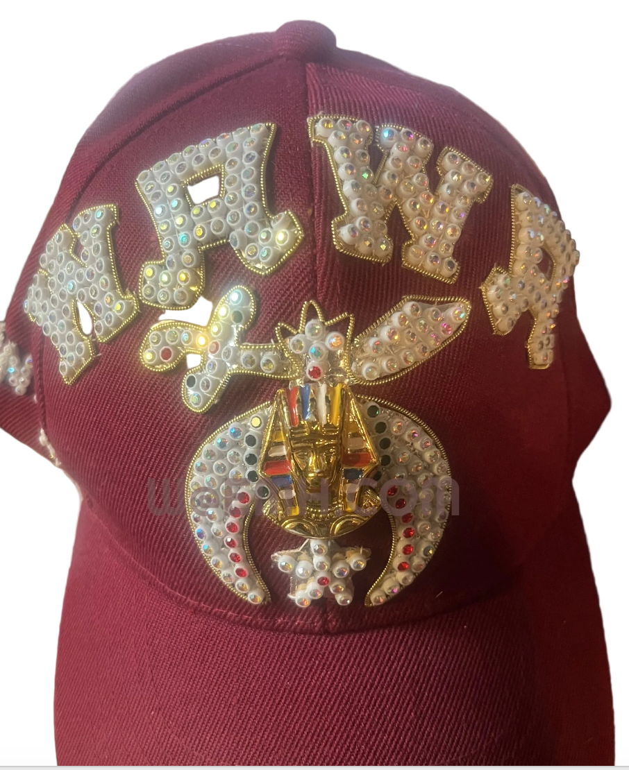 Burgundy jeweled Shriner cap with rhinestone lettering and emblem on white background